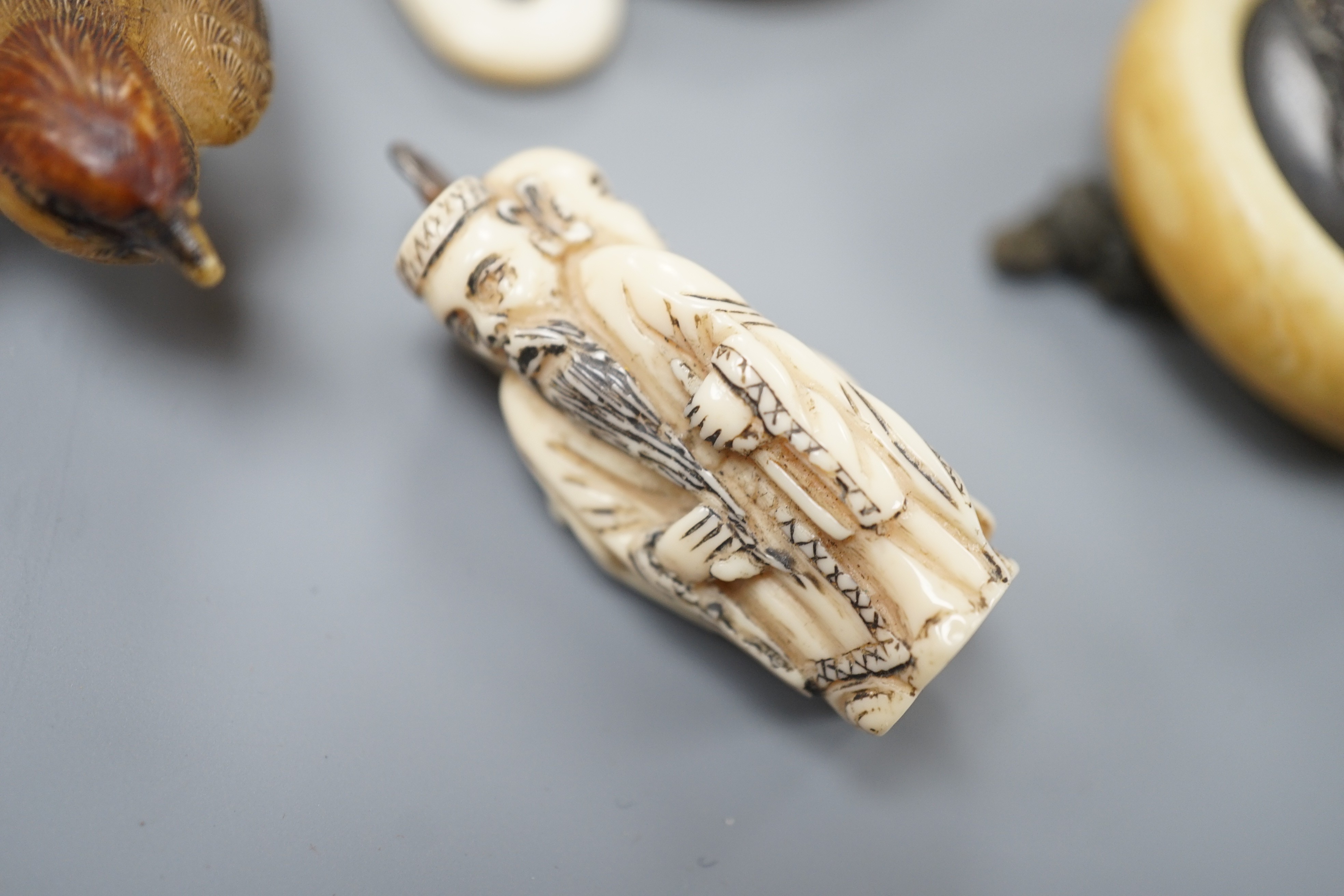 Two Japanese lacquer boxes, an ivory and bronze manju, an ivory ‘lion’ two-piece belt buckle and two simulated ivory items, late 19th/early 20th century, largest Box 11.5 cm